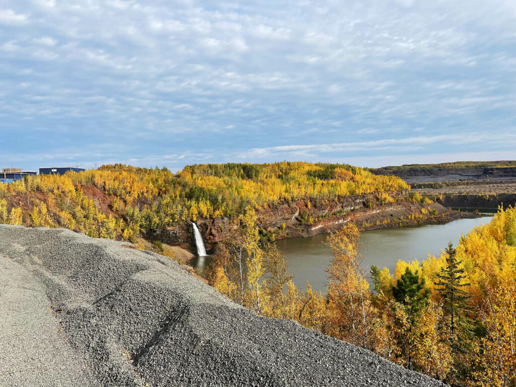 A view of a nearby lake from atop a pile of iron ore pellets